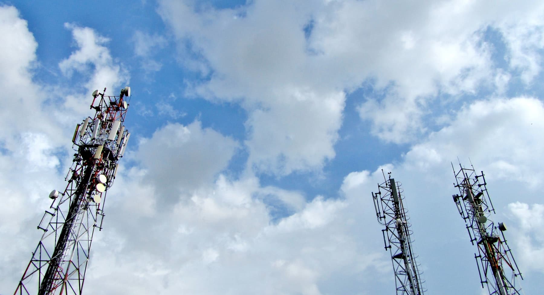 Telecom towers against a blue sky